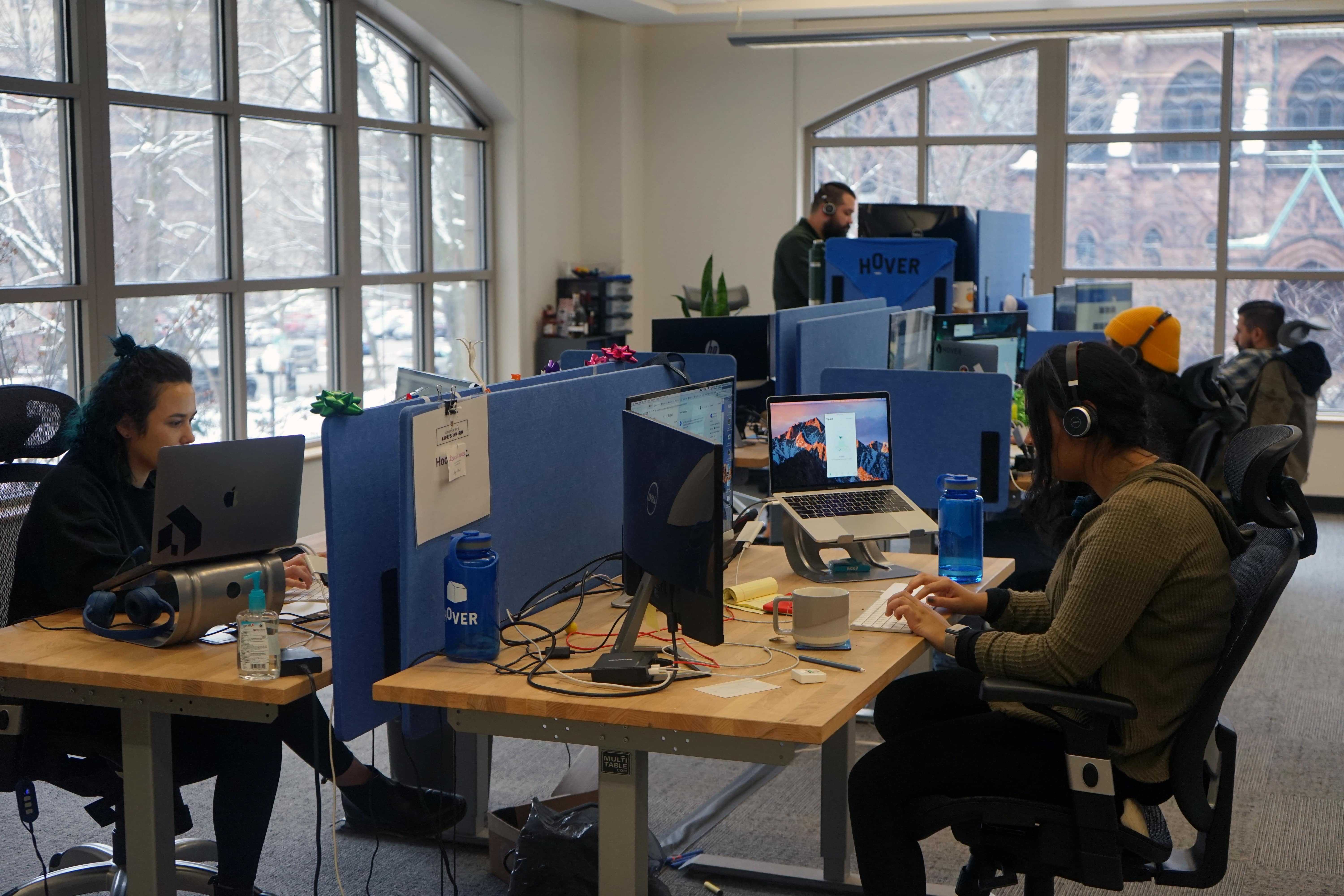 Hover employees working at desks