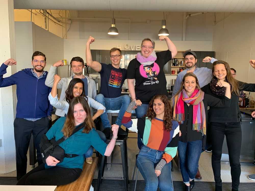 HOVER employees posing with flexed arms